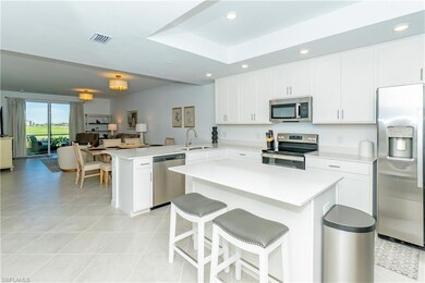 Kitchen featuring appliances with stainless steel finishes, light tile patterned flooring, a peninsula, light countertops, and recessed lighting