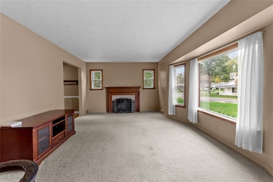 Spacious living room with large picture windows and fireplace. Tons of natural light!