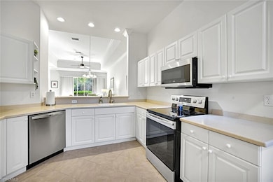 Kitchen with white cabinetry, newer stainless steel   appliances, and  recessed lighting.