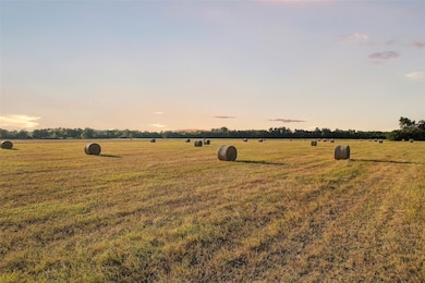 Yard at dusk with a view of countryside, a lawn, 