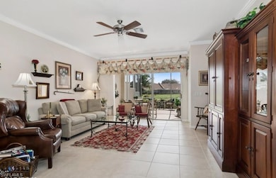 Tiled living room with ceiling fan and ornamental 