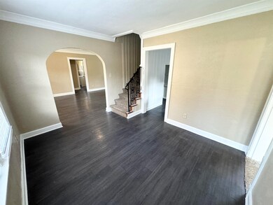 Spare room with crown molding and dark hardwood / 