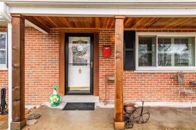 Large front porch with updated touches offers plenty of space for seating and decor.