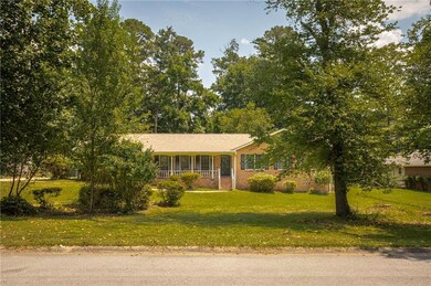 View of front of house with a front lawn and brick siding