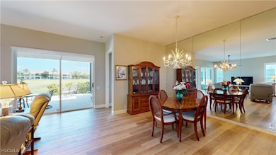 Dining area with light wood-type flooring and a chandelier