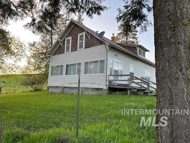 Rear view of house with a chimney, a yard, and a sunroom