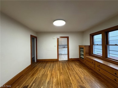Spare room featuring hardwood / wood-style floors and sink
