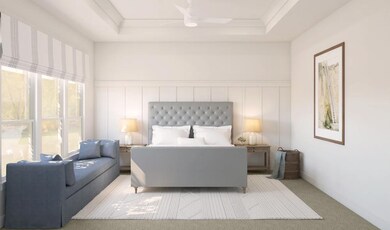 Primary suite with decorative feature wall and tray ceiling