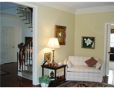 Living Room. The generous living room is designed for easy furniture placement, neutral walls, exposed hardwood and detailed crown molding.