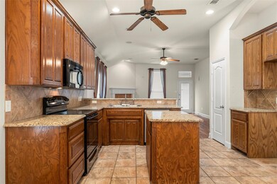 Island kitchen with granite countertops and lots o