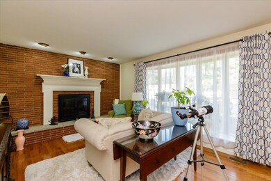 Living Room with Brick Accent Wall and Wood Burnin