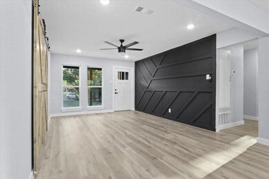 Unfurnished living room featuring visible vents, l