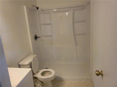 Full bathroom with a shower, toilet, and vanity