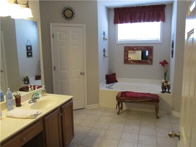 The master bathroom has his & her vanities, whirlp