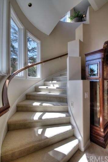 Curved main stairway to upper level. One of two st