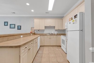 Kitchen featuring kitchen peninsula, white applian