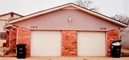View of property exterior featuring a garage and a