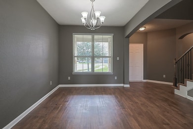 Unfurnished dining area featuring dark hardwood /