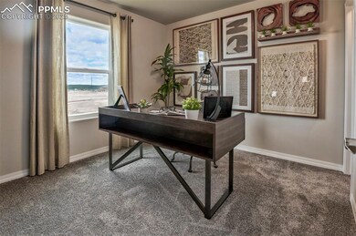 Home office with carpet floors and baseboards