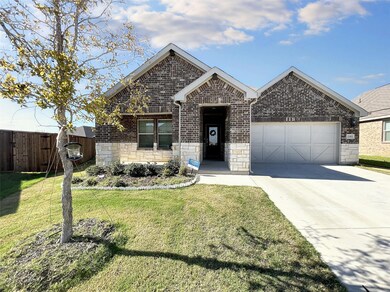 View of front of house with a front yard and a garage