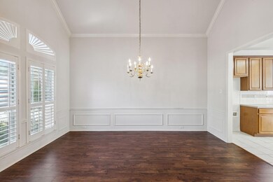 Unfurnished dining area with tile flooring, a healthy amount of sunlight, crown molding, and an inviting chandelier