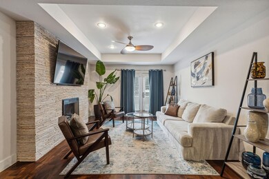 Living room featuring a fireplace, dark hardwood /