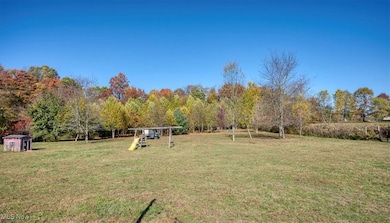 View of green lawn featuring a playground