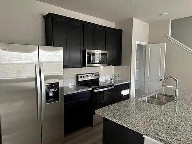 Kitchen featuring stainless steel appliances, dar