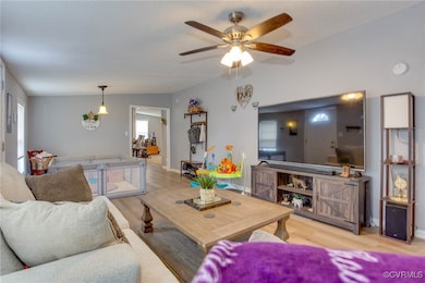 Living area featuring vaulted ceiling, a textured