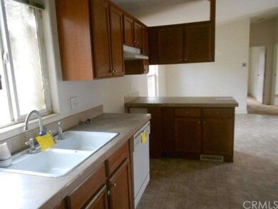 side of kitchen, dishwasher, sink shown, no stove