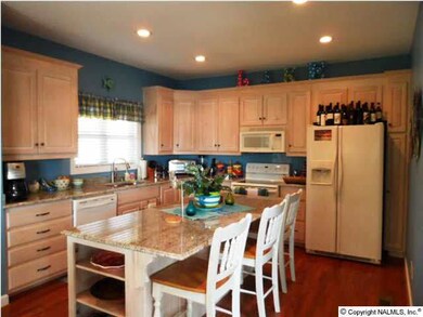 Eat in Kitchen with lots of cabinets for storage, large center island with bar area. Granite counter tops, wood flooring, smooth ceiling, recessed lighting, 9ft+/-ceiling, dishwasher, range oven, microwave, and did I mention you can enjoy the view from yo