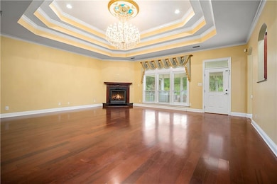 Unfurnished living room with ornamental molding, a