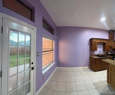 Kitchen with a wealth of natural light, sink, light tile patterned floors, and electric stove