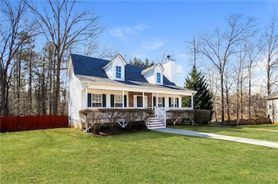 New england style home featuring a porch and a chimney