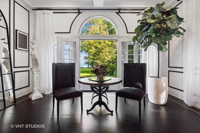 Living Room w/ multiple sitting areas and Wainscot