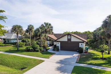 View of front facade with a garage, a front yard, 