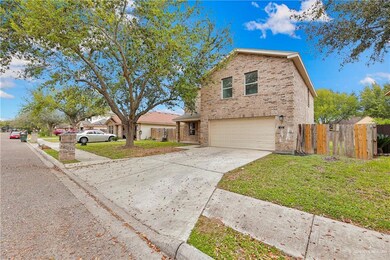 View of property with a front yard and a garage