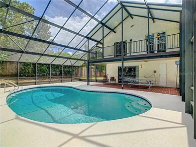 Back view of the home, upstairs balcony, lanai and
