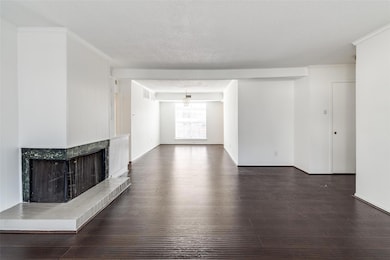 Unfurnished living room featuring dark wood finish