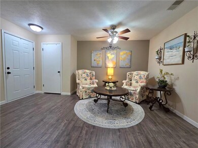 Sitting room featuring baseboards, a ceiling fan, 