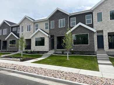 View of front facade with a front yard and stucco siding