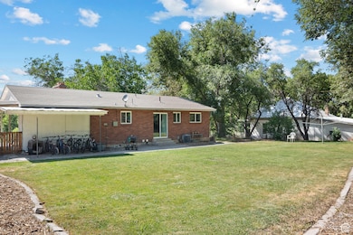 Rear view of house featuring entry steps, a patio area, and brick siding