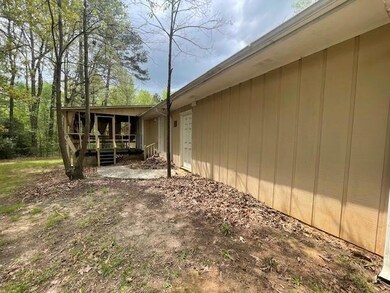 View of home's exterior with a wooden deck