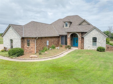 French country inspired facade with a shingled roof, a front lawn, brick siding, and stone siding