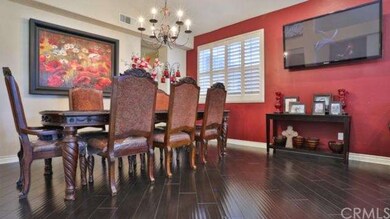 Formal dining area with custom paint wood flooring