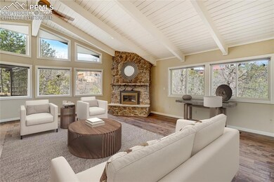 Living room with beamed ceiling, hardwood flooring