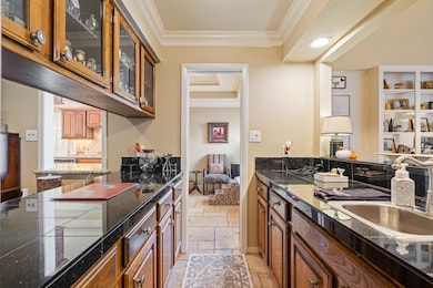 This photo showcases a charming and functional butler’s pantry/wet bar area that serves as a stylish connector between the main living spaces.