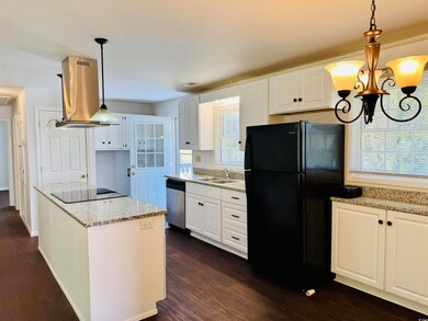 Kitchen with a sink, light stone countertops, exha