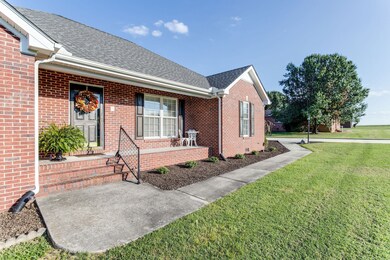 Welcoming covered front porch with sidewalk leading to driveway. Roof replaced in 2018. HVAC & hot water heater replaced in 2020.