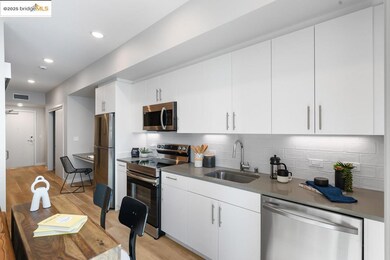Kitchen with appliances with stainless steel finishes, decorative backsplash, white cabinetry, light wood-style flooring, and recessed lighting